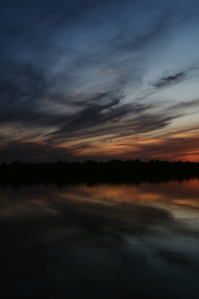 beautiful sunset on the river bank. dramatic sky of different colors. sunset