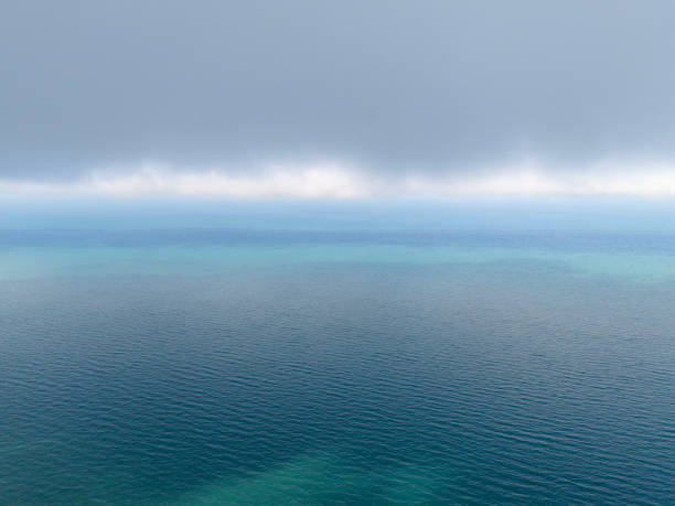 Aerial view of endless sea and cloudy sky.