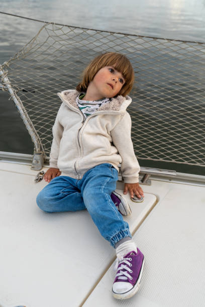 istock child sits relaxed on board a yacht 2155689835