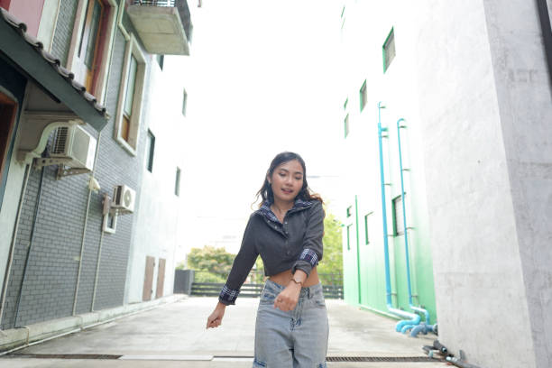 istock Young Thai woman dancing outdoors 2155694134