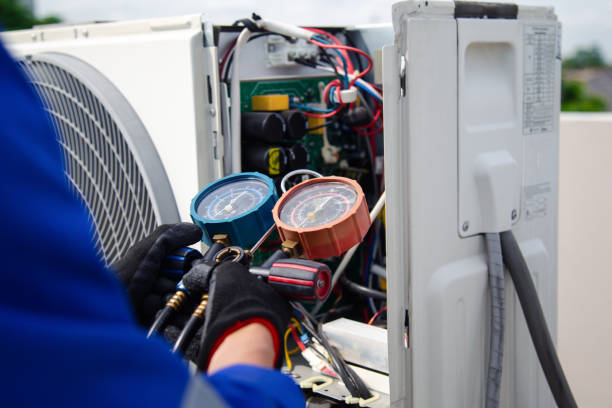 istock Air conditioner service .The air conditioner technician is using a gauge to measure the refrigerant pressure. air compressor. 2155697133