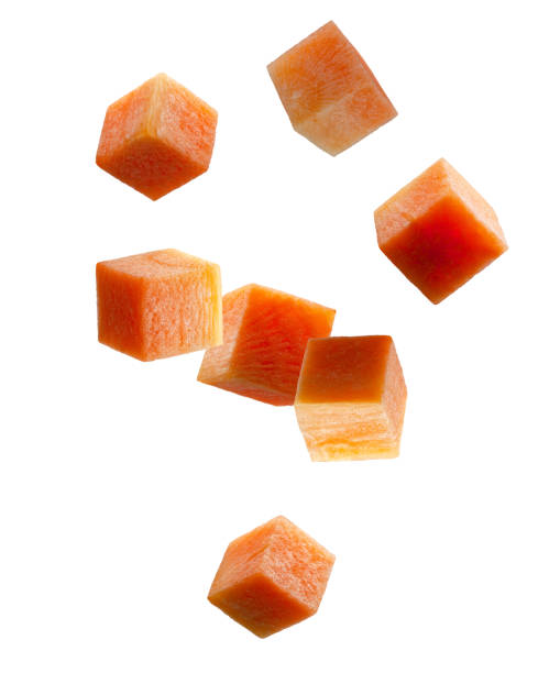 istock Carrot cubes fall in space. Volumetric back light. Isolated on white 2155698066