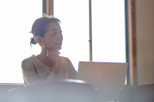istock Senior female manager in a suit working in the office 2155702583
