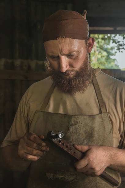 Blacksmith checks the dimensions of a forged part using a template. Close-up