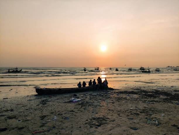 istock silhouettes of people playing on the beach at sunset 2155705943