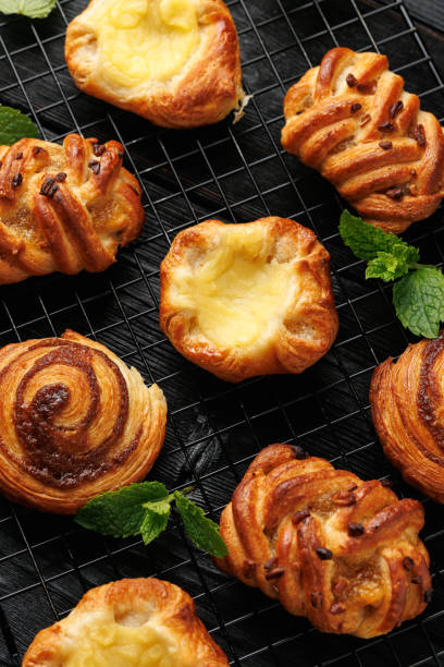 istock Mini danish pastry selection. Maple pecan plaits, cinnamon swirls and vanilla creme crowns 2155707368