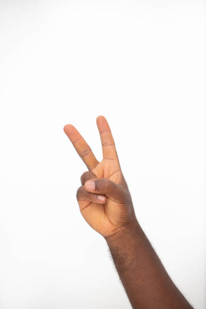 istock black Hand making peace sign gesture over white background 2155709474
