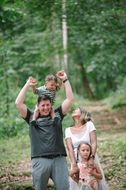 istock Diverse family multi generation having fun exploring nature in the forest traveling new experience relaxes together with hapiness moment 2155709707