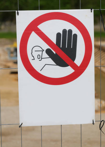 istock unauthorized entry prohibited sign with no words or writing and a barred hand outside the restricted area 2155710267