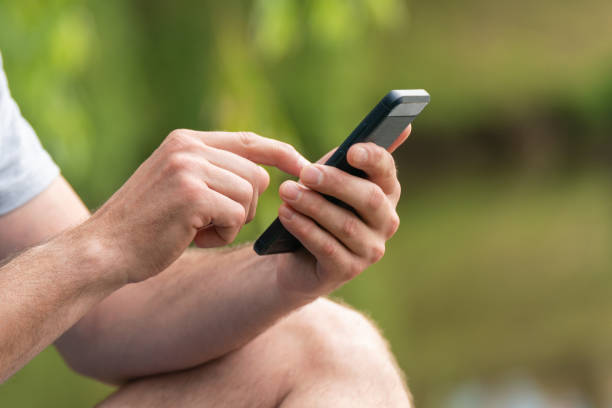 istock A man holds a smartphone in his hands in nature 2155713711