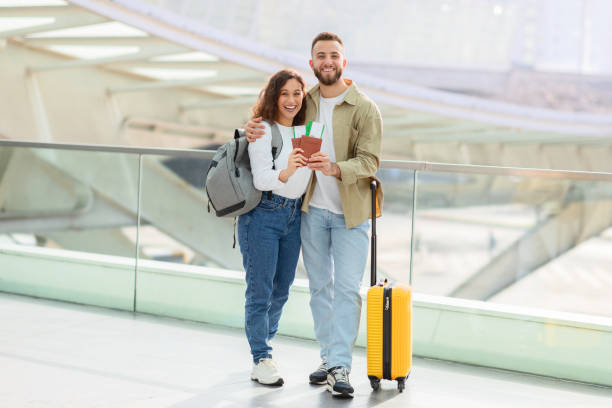 istock Vacation Trip. Happy Young Spouses With Travel Documents Posing In Airport Terminal 2155714321
