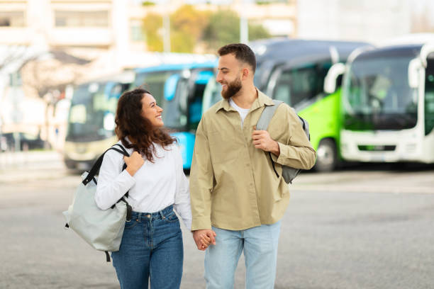 istock Couple walking and smiling at bus station 2155714324