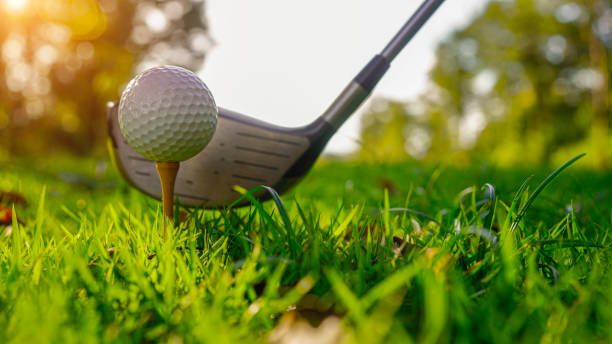 istock Golf balls on the golf course with golf clubs ready for golf in the first short. 2155719081