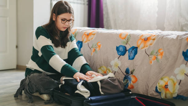 istock Girl is packing her suitcase for the summer vacation 2155720035