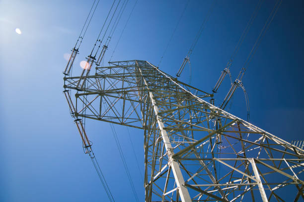 Blue sky and high voltage tower seen from below