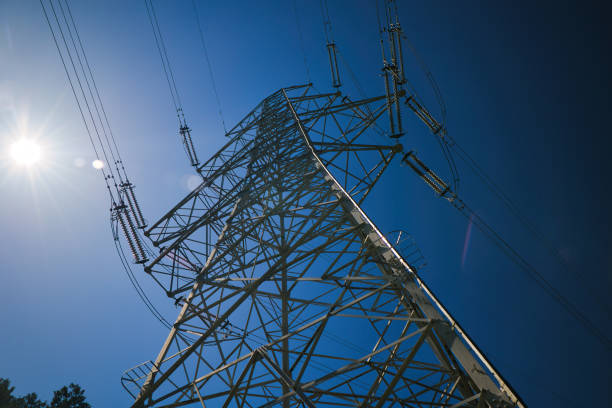 istock Blue sky and high voltage tower seen from below 2155723140