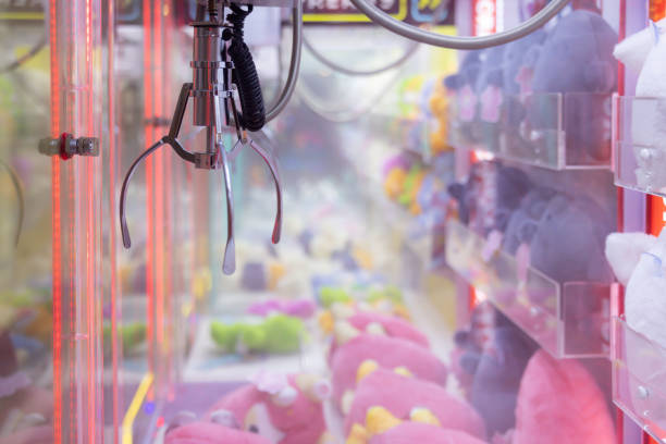 istock A claw machine with a pink stuffed animal in the middle 2155723572