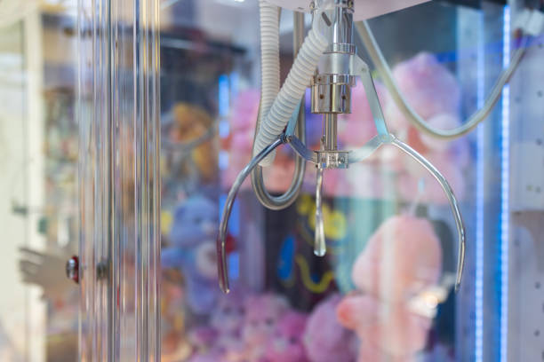 istock A claw machine with a pink stuffed animal dolls in the middle. 2155723609
