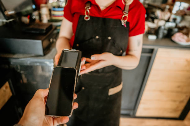 istock customer paying bill with phone in a cafe. 2155724828