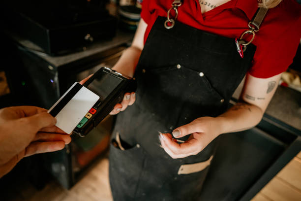 istock customer paying bill with credit card in a cafe. 2155724849