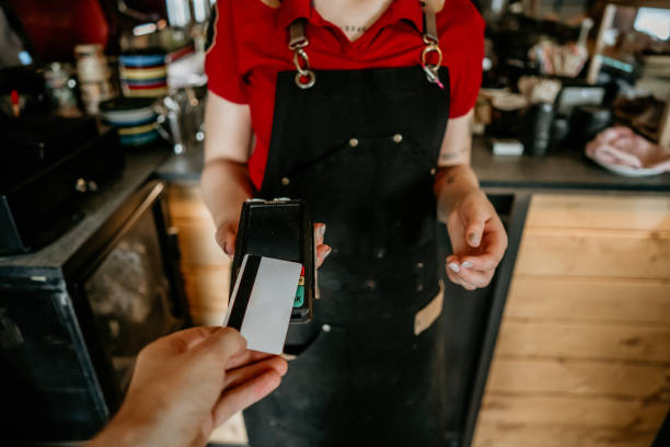 istock customer paying bill with credit card in a cafe. 2155724861