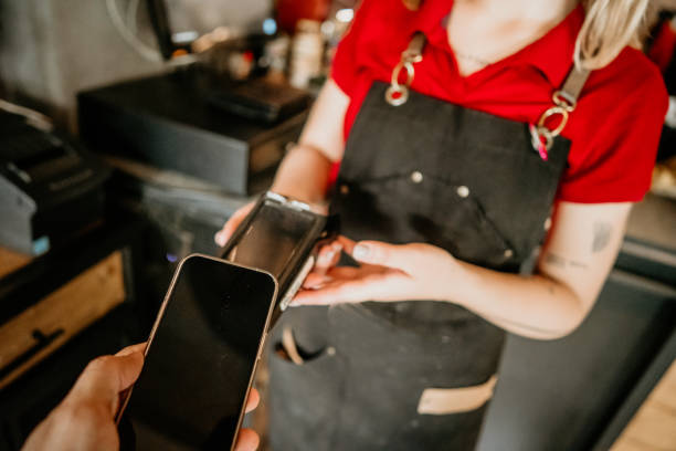 istock customer paying bill with phone in a cafe. 2155724871