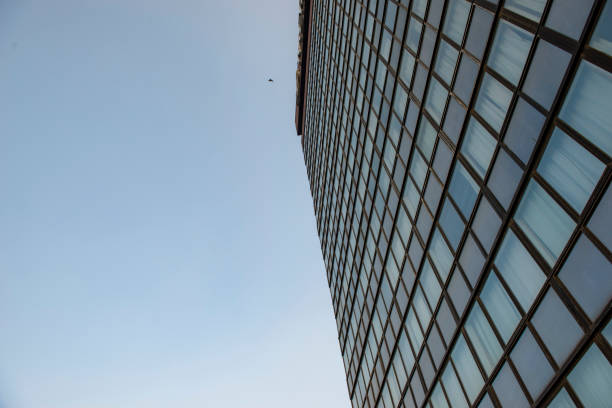 Close-up of the architectural facade of a hotel building in Delhi, showcasing its windows against a backdrop of the sky.