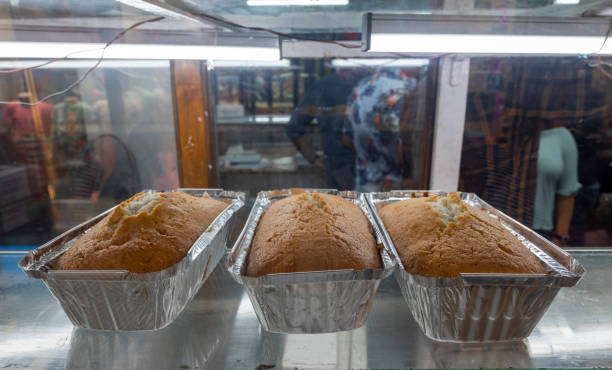 Plum cakes in aluminum foil containers at Nahoum and Sons Bakery, located in Kolkata's New Market, a renowned shop in the city.