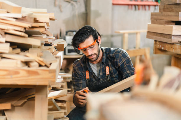 istock Diligently skilled man work with wood in carpenter's shop, using tools and equipment to transform timber planks into bespoke wooden pieces, craftsmen workshop with natural material, furniture industry 2155727562