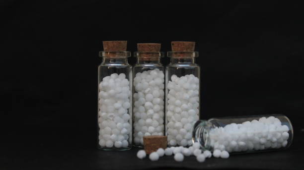 Homeopathy medicines. Homeopathic medicines in glass bottles. Alternative system of medicine. Creative photography for Homeopathic concept. rajkot india stock pictures, royalty-free photos & images