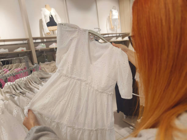 Woman looking clothing to buy in clothes store