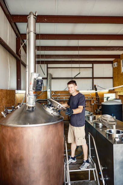 istock Mid adult male whisky distiller working at distillery 2155731463