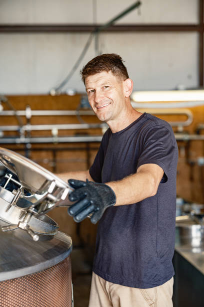 istock Mid adult male whisky distiller working at distillery 2155731464