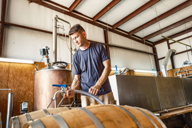 istock Mid adult male whisky distiller working at distillery 2155731485