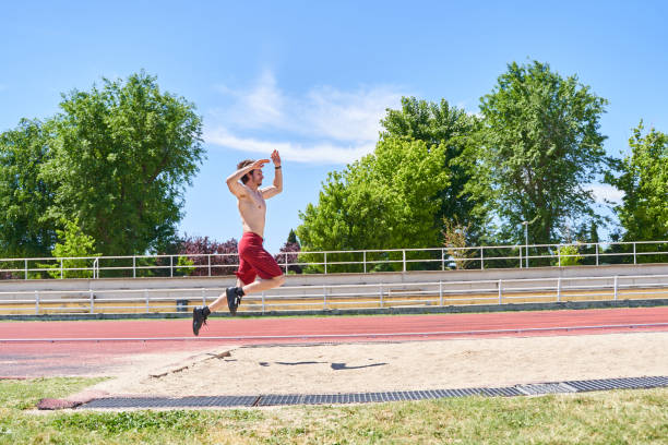 Close-Up Of Sports Shoes On Running Track Field