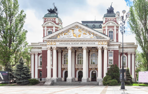 Front facade of the National Theatre Ivan Vazov, the National Theatre of Bulgaria, which faces onto the City Park in Sofia. The Neoclassical building was designed by  Hermann Helmer and Ferdinand Fellner, and opened in 1906.