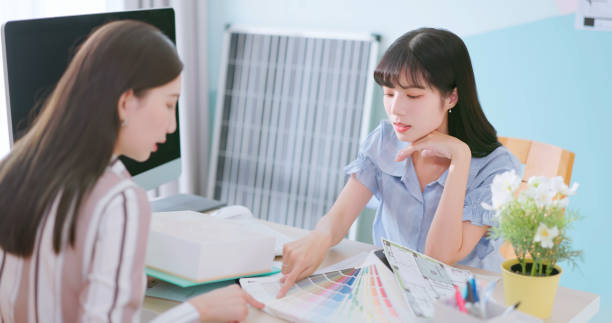 asian young woman is discussing with interior designer about her new house