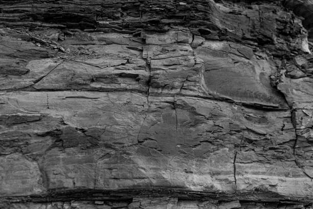 Old Aged Shabby Cliff Face And Divided By Huge Cracks And Layers.