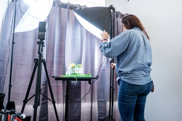 istock Female Photographer Making a Shooting with a Camera in a Professional Studio. 2155749031