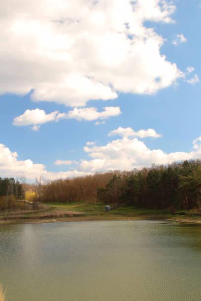 A body of water with trees around it. Sky. Water. Outdoor. River. Nature