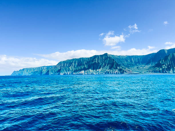 Na Pali Coast, Kauai from ocean. Cliffs rise majestically out of the sea, evidence of the volcanic origin of the island.