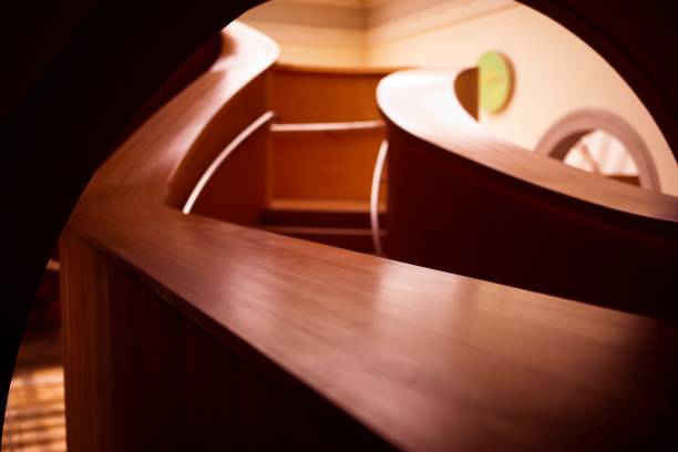 istock Curved Wooden Staircase with Warm Lighting 2155753119
