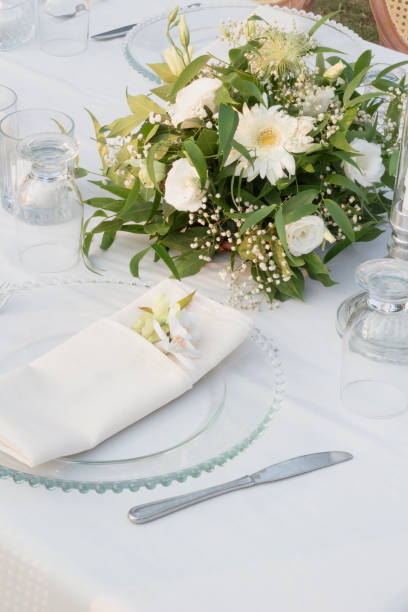 istock Wedding table decoration with fresh colorful flowers, plates and candles 2155753367