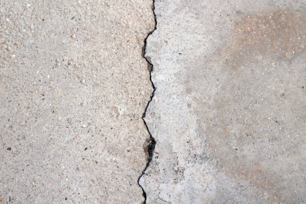 istock Broken asphalt roads, caused by earthquake. A large crack in concrete. 2155754409