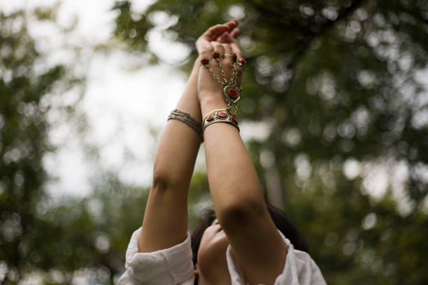 body language of young woman among green trees in spring season