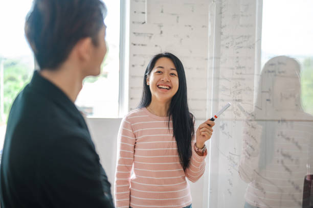 istock Strategic Planning: Young Chinese Colleagues Brainstorming for APEC 2155755226