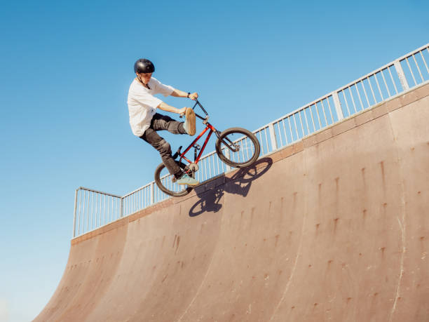 istock BMX bicycle rider doing trick One Foot Can-Can 2155755326