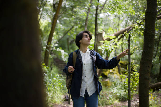 istock young lady with short hair spending time in the park 2155756304