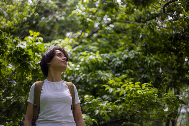 istock young lady with short hair spending time in the park 2155756548
