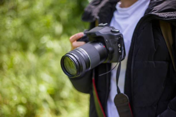 istock nature photographer and camera in hand 2155757463